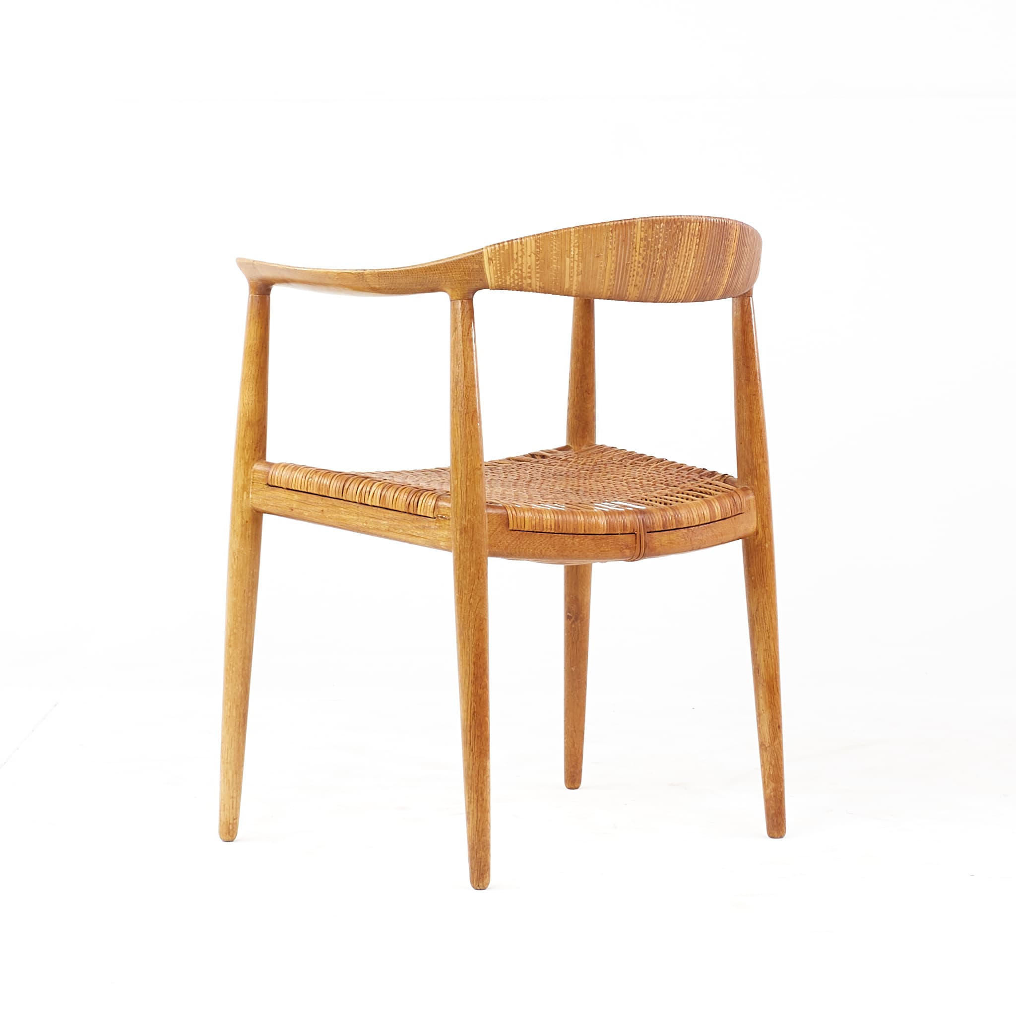 Hans Wegner JH-501 "The Chair" with a woven cane seat on a light frame